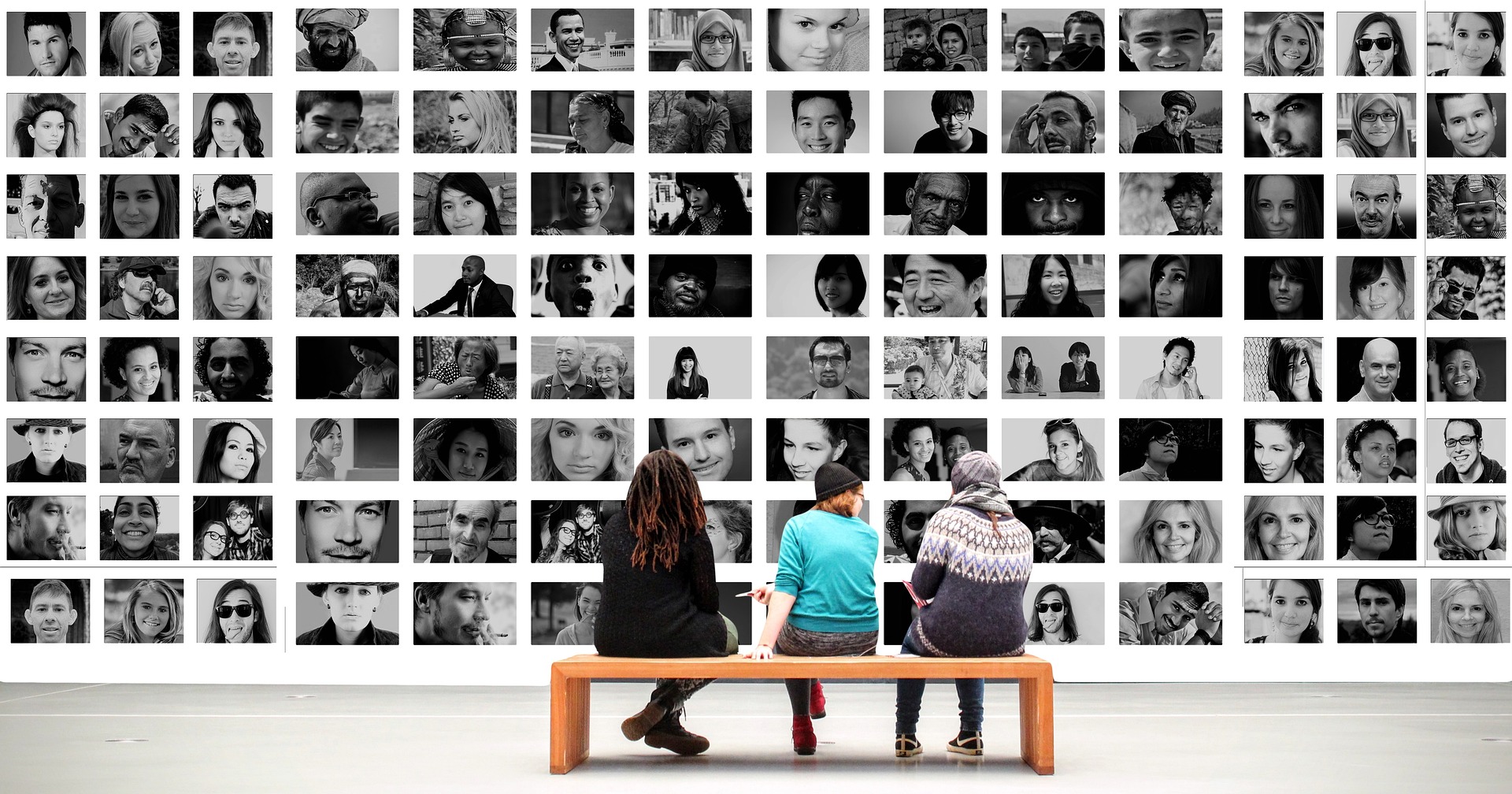 A group of people looking at a photography exhibit
